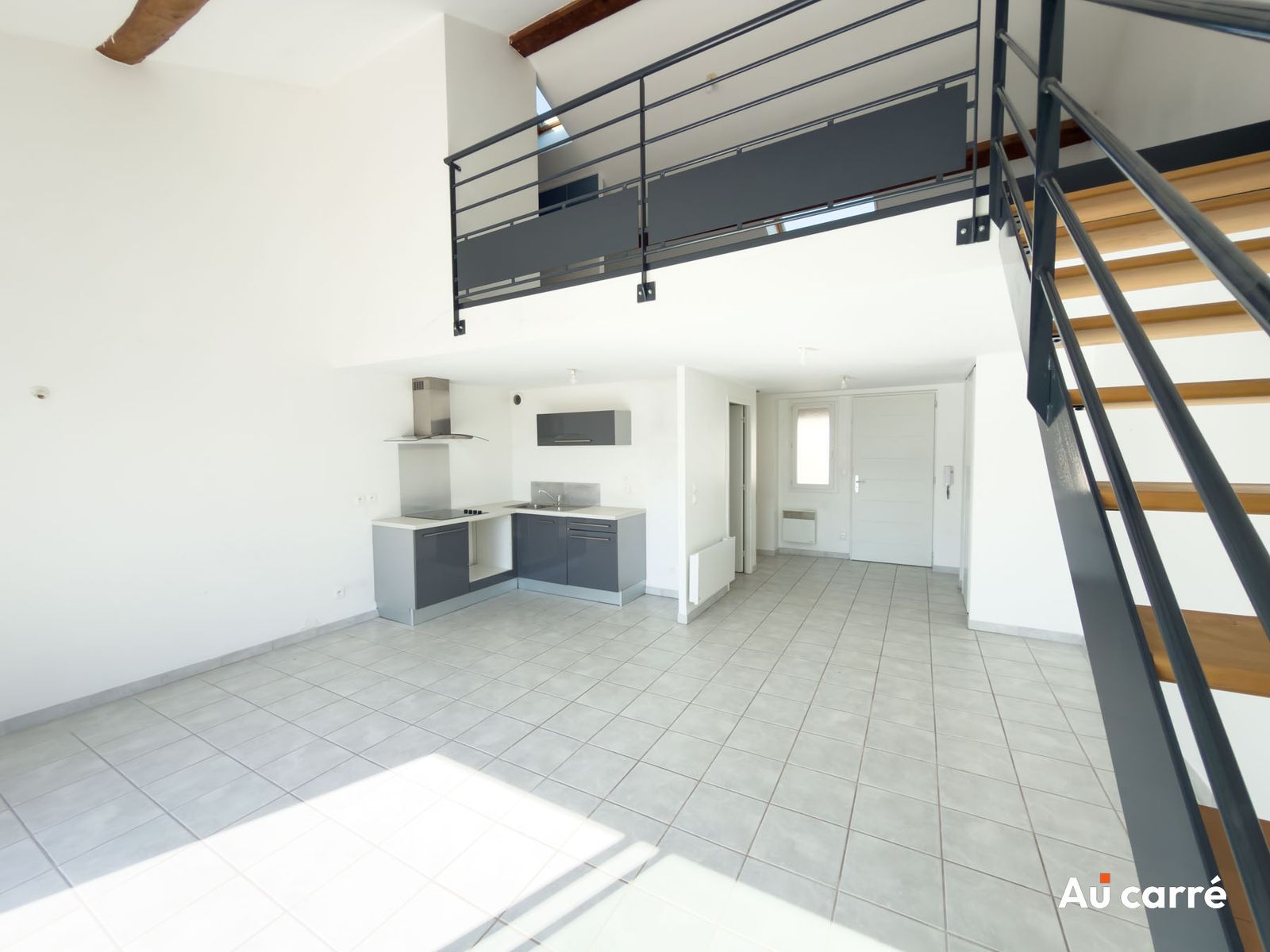 Vue d'ensemble du séjour et de la cuisine depuis l'escalier